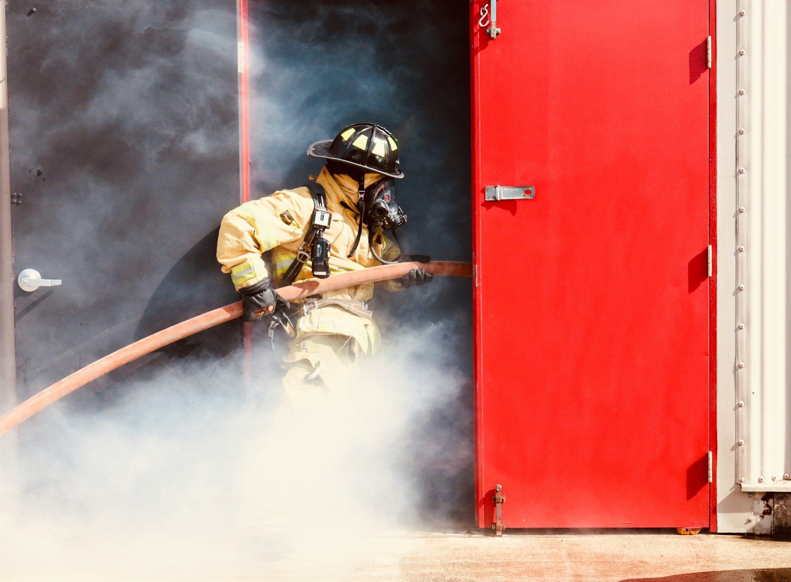 a firefighter is using a hose to extinguish a fire